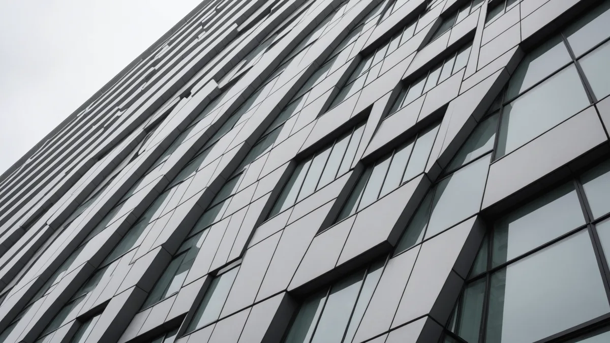 Architectural detail of a modern London building facade, ordered vertical lines, muted stone tones